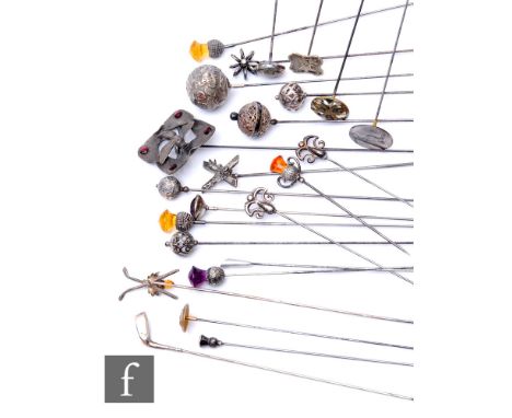 A collection of early 20th Century and later hat pins, to include various silver hallmarked and white metal examples, thistle