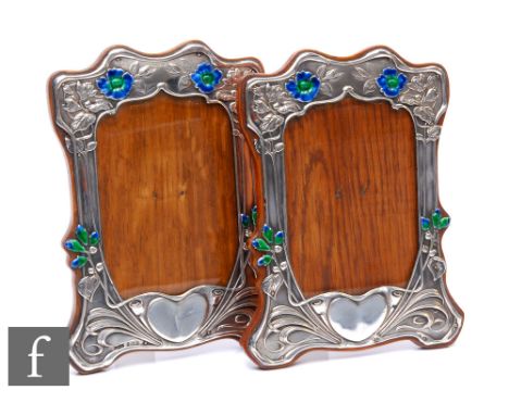 A matched pair of Edwardian hallmarked silver rectangular easel photograph frames each with vacant heart shaped cartouche, el