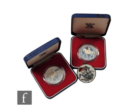 Two&nbsp;Elizabeth II 1977 Silver Jubilee crowns each boxed with certificates and an 1888 enamelled back silver mounted crown