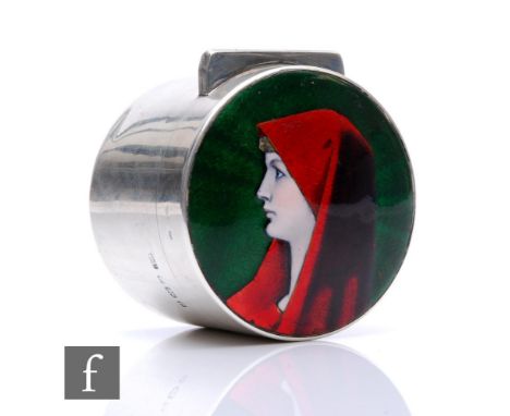 A hallmarked silver cylindrical box and cover, the hinged cover with enamelled decoration of the profile of a young woman wea