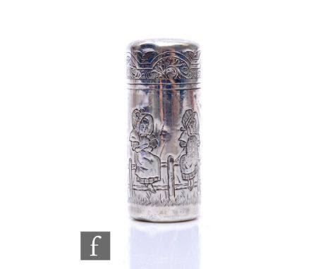 A hallmarked silver cylindrical scent bottle with engraved decoration of two Kate Greenaway style figures sat on a garden fen
