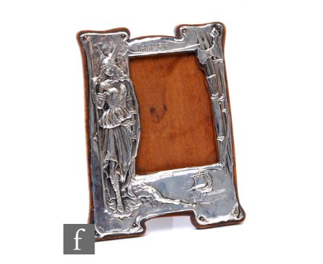 An early 20th Century silver mounted oak easel-back 'Valkyrie' photograph frame, embossed figure of Valkyrie in full battle d