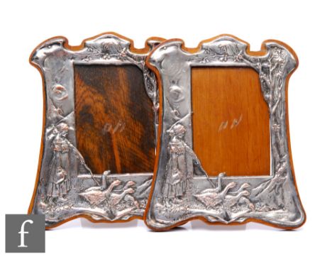 Two Edwardian silver plated rectangular easel photograph frames each embossed with a young girl tending her geese to a wooded