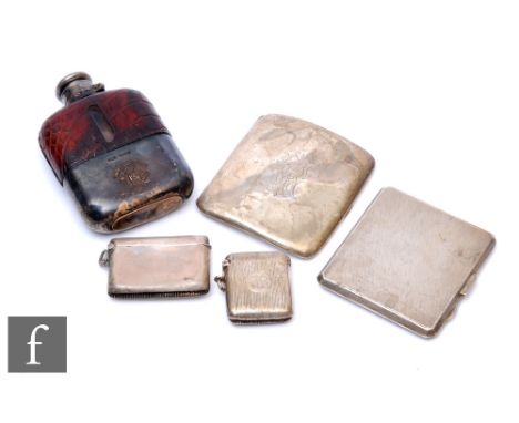A small parcel lot of hallmarked silver to include two cigarette cases, two vesta cases and a glass and leather hip flask, we