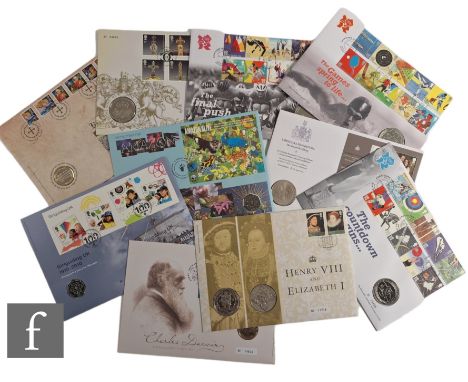 An album of first day cover coins to include a Charles Darwin fifty pence, Olympic Games 2012 five pound coins and others.