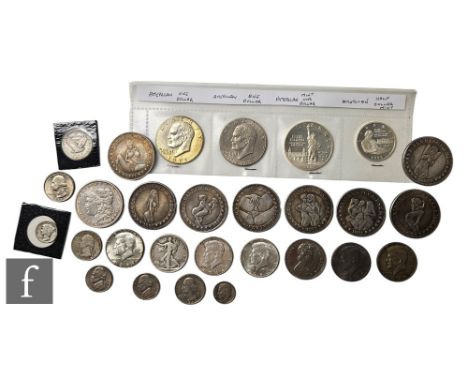 An American 1879 Morgan dollar, a 1943 half dollar, various Liberty nickel 1970 and 1980s dollars and a small collection of e