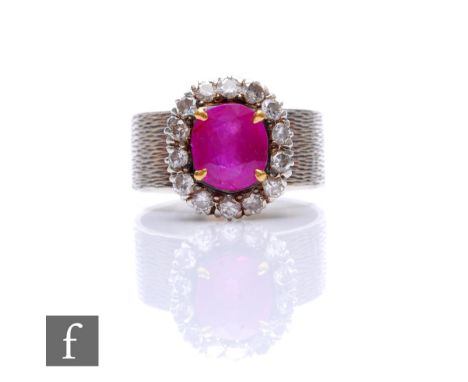 A silver ruby and diamond cluster ring, central cushioned rectangular ruby within a border of fourteen brilliant cut diamonds