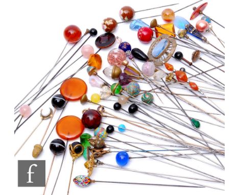 A large collection of various early 20th Century and later hat pins, all with varying finial designs, lengths ranging 8cm-28c