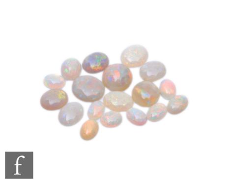 Eighteen assorted loose opal stones to include oval and cabochon cut examples, longest oval 12mm. (18) 