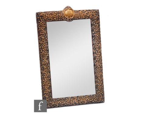 A hallmarked silver mounted easel mirror with foliate embossed decoration to whole, engraved initials to pediment, all to a r