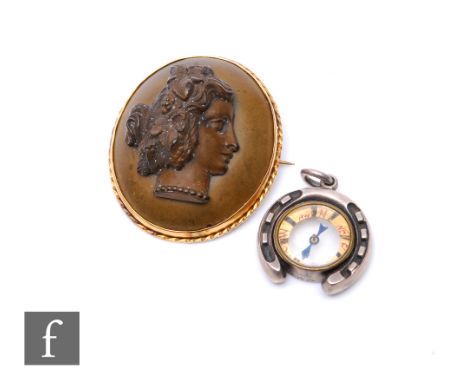 A 19th Century carved bog oak brooch, profile of a young lady to one side and a floral bouquet to the other, length 4.5cm, wi