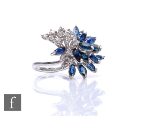 An 18ct white gold sapphire and diamond cluster ring, comprising marquise cut sapphires and brilliant cut diamonds, all stone