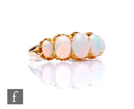 An early 20th Century 18ct graduated opal five stone ring, claw set stones to plain shoulders, weight 3.3g, ring size O 1/2. 