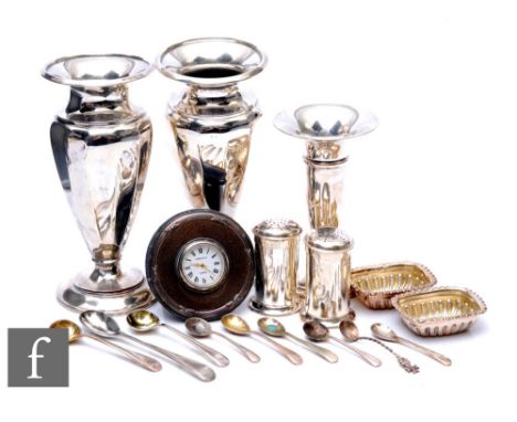A collection of George V silver hallmarked items, to include a pair of pepperettes, Chester 1921, three various vases (weight