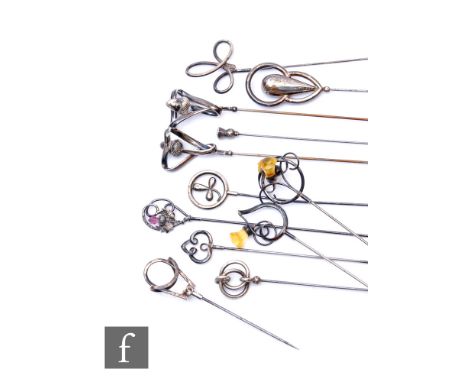 A collection of early 20th Century silver and white metal hat pins, to include stylised floral designs, thistle and shamrock 