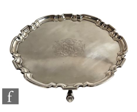 A George II hallmarked silver salver with central engraved crest and initials within stepped pie crust borders, weight 41oz, 