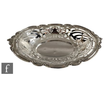 An Art Nouveau hallmarked silver oval bread basket with pierced whiplash decoration below scroll borders, weight 15.5oz, leng