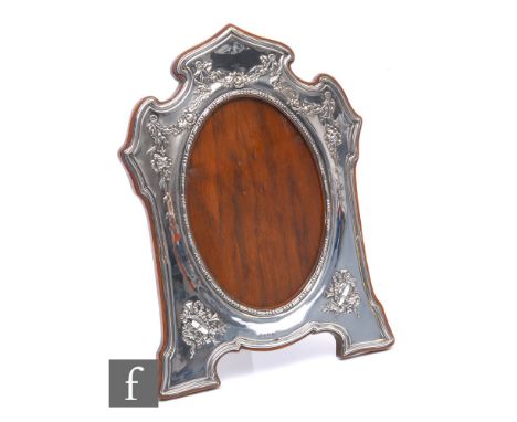 An Edwardian hallmarked silver rectangular easel photograph frame embossed with floral swags around oval aperture and within 