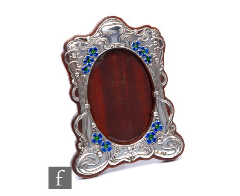 An Edwardian hallmarked silver rectangular easel photograph frame decorated with later enamelled blue/green flower heads and 