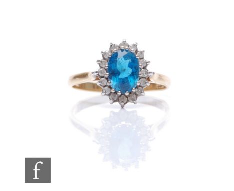 An 18ct hallmarked blue zircon and diamond cluster ring, central zircon within a diamond set border, weight 3.5g, ring size P