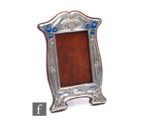 An Edwardian Art Nouveau hallmarked silver rectangular easel photograph frame with embossed leaf and berry decoration and six