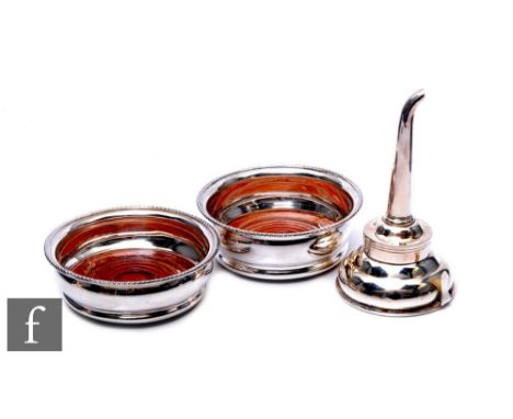 A matched pair of silver hallmarked wine coasters of plain form with reeded rim border,&nbsp;diameter 11cm, Birmingham 1982 a