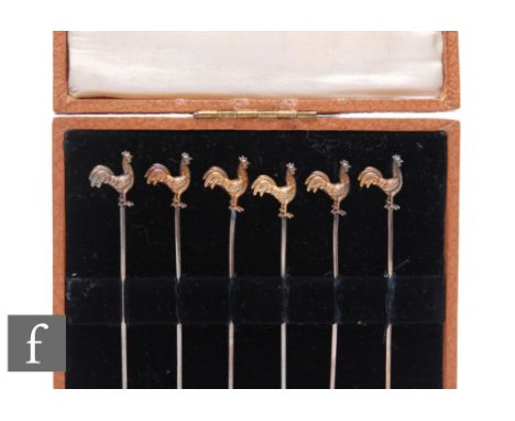 A cased set of six silver cocktail sticks each terminating in the gilt study of a standing cockerel, each stamped silver. 