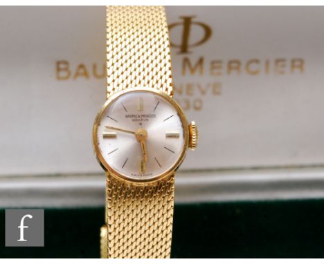 A lady's 18ct Baume &amp; Mercier manual wind wrist watch, gilt batons to a silvered circular dial, case diameter 15mm, to an