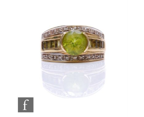A 9ct hallmarked peridot and diamond ring, central circular peridot flanked by baguette cut examples, all within a diamond bo