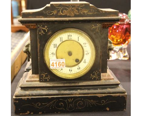 Cast iron cased mantel clock with lion mask handles and pendulum. P&amp;P Group 3 (£25+VAT for the first lot and £5+VAT for s