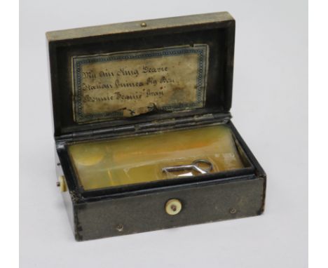 A 19th century bois durci musical snuff box