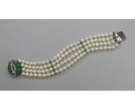 A modern multi strand cultured pearl bracelet with 14 ct white gold and jadeite clasp, 18 cm approx.