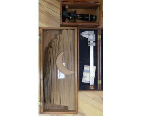 A boxed set of draughtsmans tools and a microscope