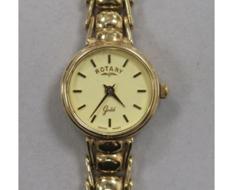 A lady's Rotary 9ct gold manual wind wrist watch, on a 9ct gold bracelet.