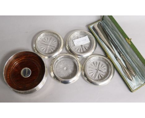 A silver coaster, four others, a cased shoe horn and button hook