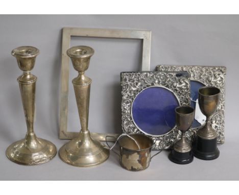 A pair of silver tapered candlesticks (weighted) and sundry items, including a pair of silver-mounted photograph frames cast 