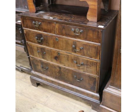 An early 18th Century walnut chest of two short and three long graduated drawers, on bracket feet (adapted from a chest on ch