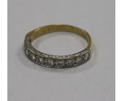 An early 1970's 18ct gold and ten stone diamond half eternity ring, size Q.