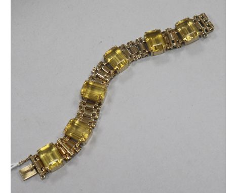 A 1950's 9ct gold and emerald cut citrine set bracelet, 18.7cm approx.