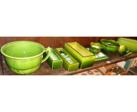 Shelf of green Art Pottery, mainly Bretby