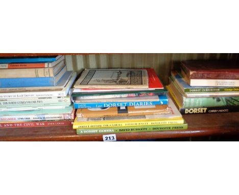 Shelf of local interest books with 1940's Bridport Town Guide