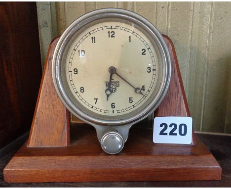 A Smiths car clock on wood stand