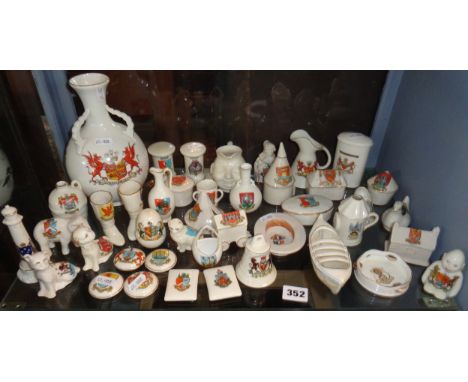 Shelf of Crested China items, Goss, Arcadian etc