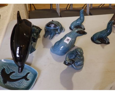 A Poole blue glazed dolphin, two badgers, two seals and two other items (7)