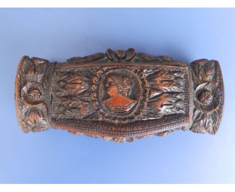  An early 19thC coquilla nut snuff box, the hinged cover carved in high relief with a female portrait bust, the box decorated