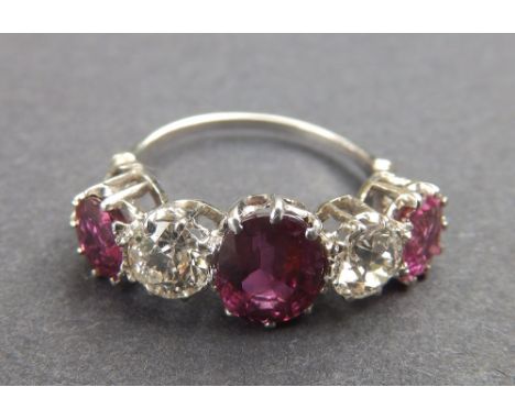 A five stone ruby & diamond ring, claw set in white metal, accompanied by a GCS (London) Lab report stating the rubies be unt