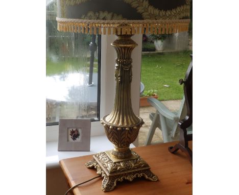 A reproduction style brass table lamp.