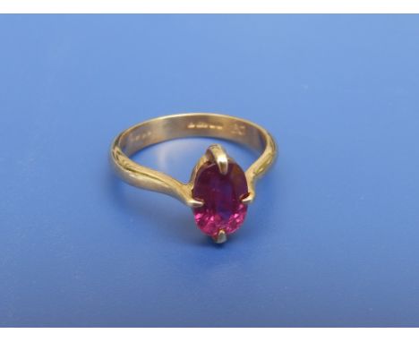 A modern ruby solitaire ring, the oval cut stone weighing approximately 2 carats, four claw set in 18ct gold.