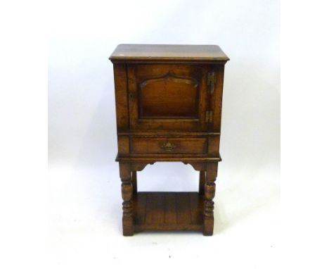 Good quality reproduction mid 18th Century style oak cupboard Mid single door with fielded panel above pull out slide and sin