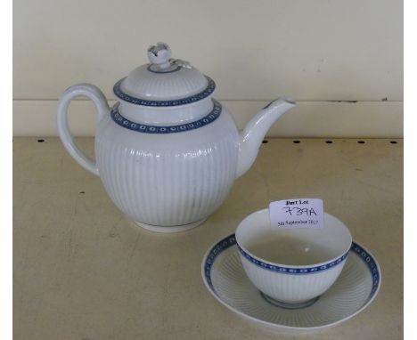 An 18th Century Worcester teapot of bulbous formHaving moulded panelled decoration with blue and white border, height 15cm, t